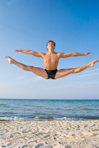 man jumping on beach
